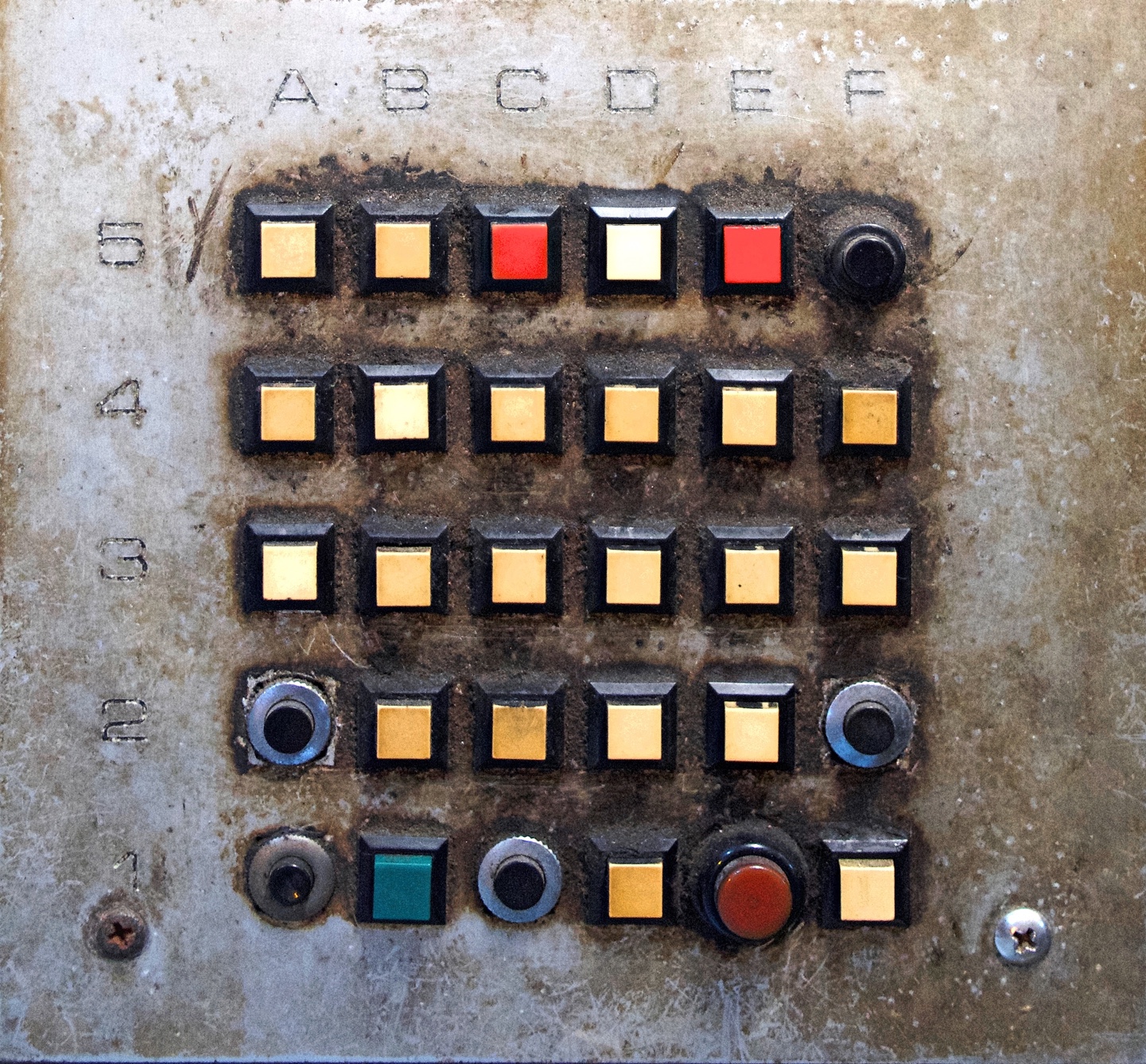A building call system, with buttons mixed of different colours and shapes.